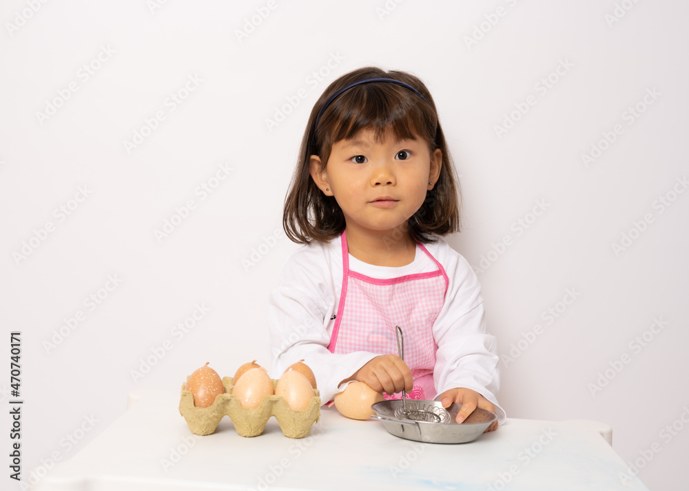Beautiful little asian girl cooking isolate on white background Beautiful little asian girl cooking isolate on white background