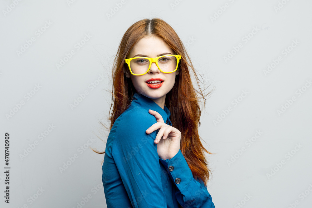 woman in blue shirt yellow glasses posing fashion woman in blue shirt yellow glasses posing fashion