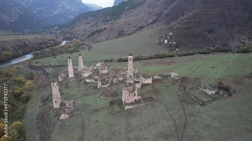 Ancient tower complex Egikal filmed by a drone flying clockwise. Republic of Ingushetia. Caucasus mountains, Russia photo