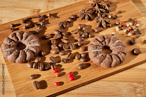 Cookie. Coffee beans. Barberry, cloves, star anise, carnation, peppers on a wooden board.