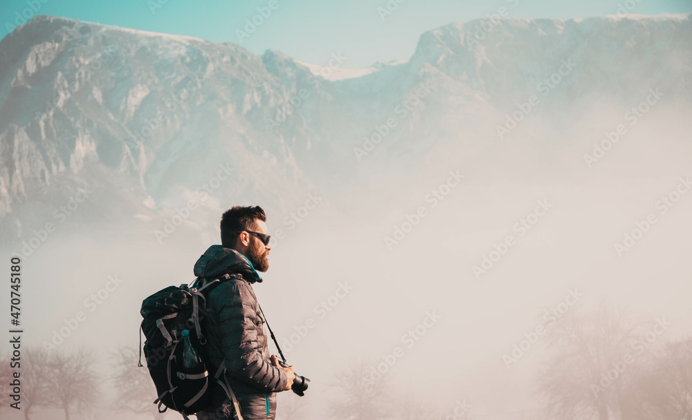 portrait of handsome man trekking in mountains in winter  outdoor adventure active lifestyle and social distancing space for your text