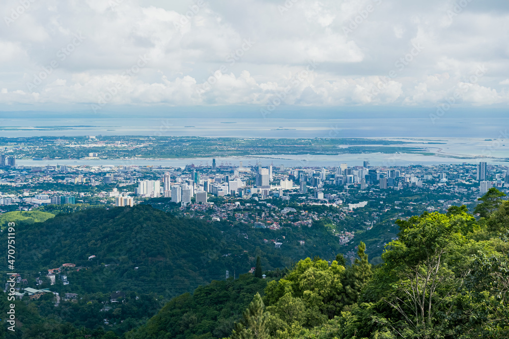Aerial view of Cebu cityscape with trees. Landscape view from top mountain.