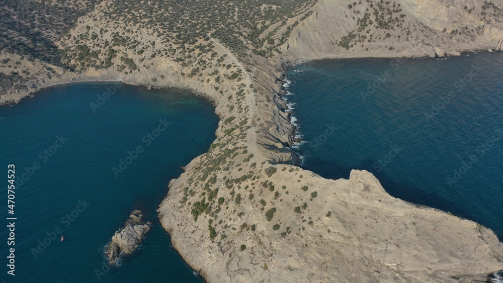 Panorama of cape Kaptchick, South Crimea. aerial photography. Blue sea and yellow rocks with green bushes. Camera straight down