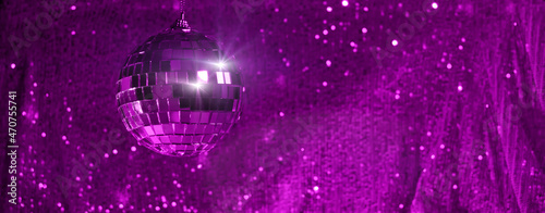 Disco ball on trendy background violet w sparkles and bokeh. Template holiday design, new year, christmas, party