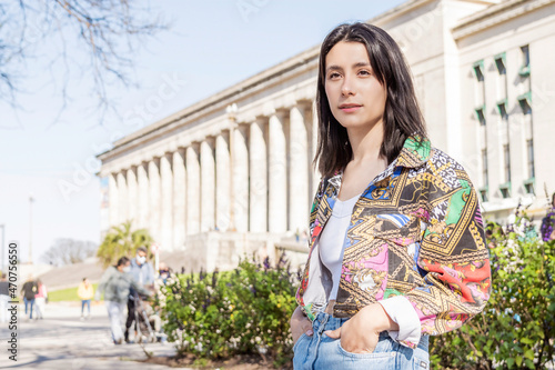 street portrait of a young black-haired woman gazing into the distance