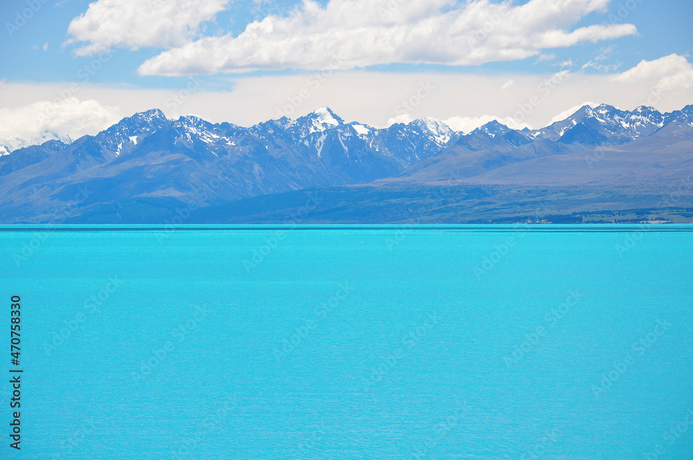 View of milky blue of Lake Pukaki with beautiful view on Southern Alps in the background in South Island New Zealand