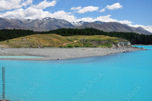 View of milky blue of Lake Pukaki with beautiful view on Southern Alps in the background in South Island New Zealand © NuFa Studio