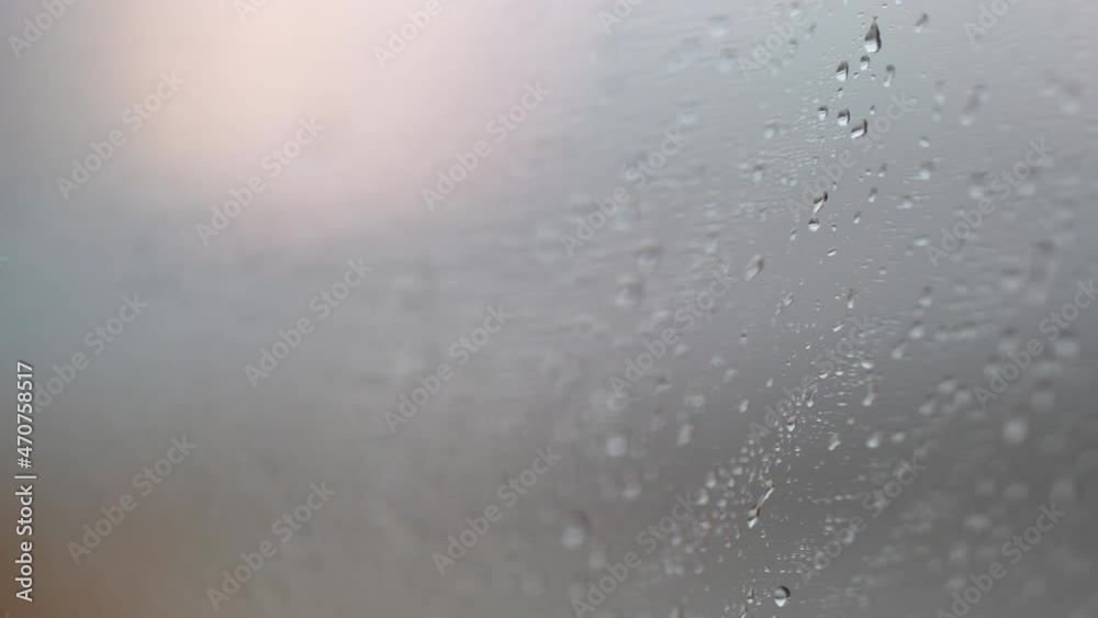 Blurred abstract droplets on window during rainy day Blurred abstract droplets on window during rainy day