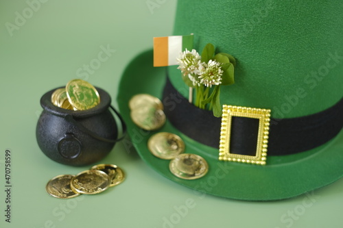 Saint Patrick background.Green leprechaun hat, flag,gold coins. Irish traditional spring holiday.Saint Patrick background.St.Patrick 's Day photo