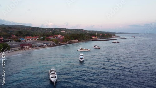 Drone flying around harbor in Nusa Penida, Bali Inodnesia in early morning sunrise. High quality 4k footage photo