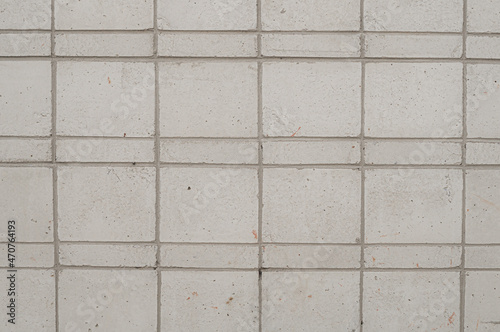 Abstract background of tile cladding of the facade of the building. Grey decorative tiles.