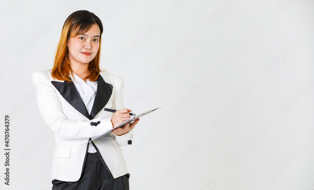 Portrait studio shot of Asian modern successful female businesswoman model in casual blazer suit look at camera holding pen writing report checklist on paper document clipboard on white background Portrait studio shot of Asian modern successful female businesswoman model in casual blazer suit look at camera holding pen writing report checklist on paper document clipboard on white background