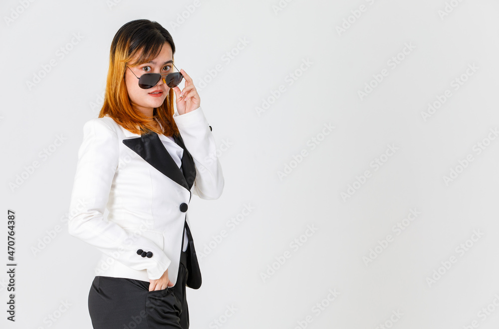 Portrait studio shot of Asian urban trendy fashionable successful female businesswoman model in casual blazer suit look at camera adjusting black lens aviator sunglasses shades on white background Portrait studio shot of Asian urban trendy fashionable successful female businesswoman model in casual blazer suit look at camera adjusting black lens aviator sunglasses shades on white background