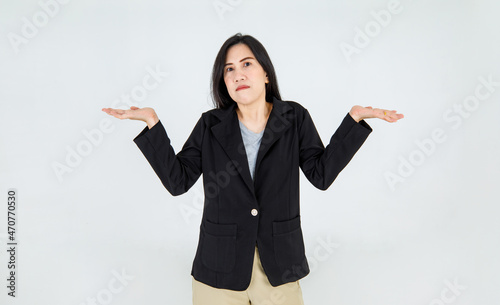 Serious Asian adult woman on business jacket as entrepreneur raise hands to say nothing matter and not care for anything that unconcerned and impassive photo