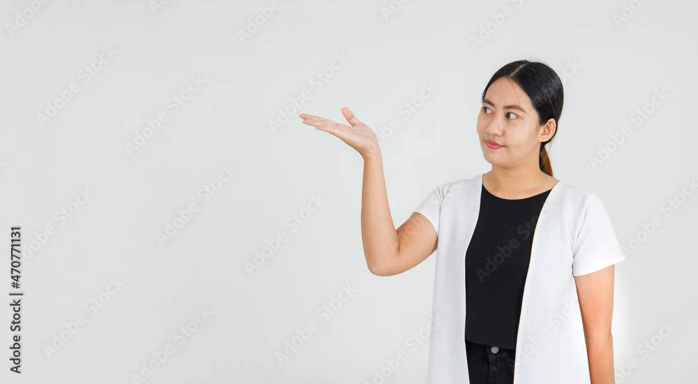 Lovely Asian girl smiling with happy and pointing finger to guide interesting direction and amazing message. Pretty girl delighted to offer attractive instruction and notice Lovely Asian girl smiling with happy and pointing finger to guide interesting direction and amazing message. Pretty girl delighted to offer attractive instruction and notice