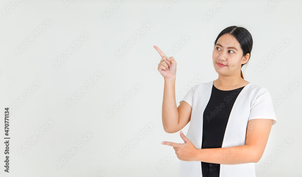 Lovely Asian girl smiling with happy and pointing finger to guide interesting direction and amazing message. Pretty girl delighted to offer attractive instruction and notice Lovely Asian girl smiling with happy and pointing finger to guide interesting direction and amazing message. Pretty girl delighted to offer attractive instruction and notice