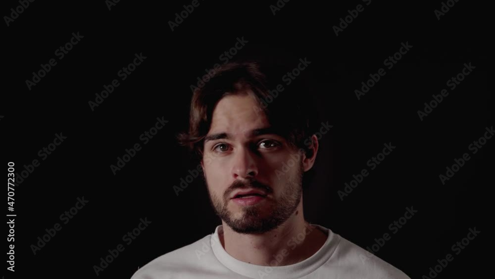 Trendy Young Man frightened gesture, scared expression, close, black background Trendy Young Man frightened gesture, scared expression, close, black background
