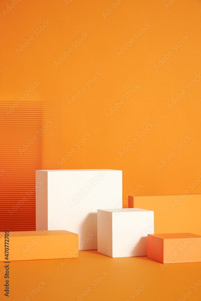 Front view of white and orange podium with and flower in a orange background for advertising , abstract content