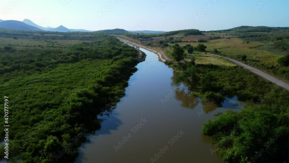 Canal, road to lake and blue sky Canal, road to lake and blue sky