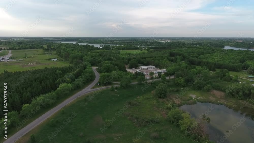 Aerial Flying Towards Nature Conservation Compound In The Middle Of Vast Forests With Trees And Water Aerial Flying Towards Nature Conservation Compound In The Middle Of Vast Forests With Trees And Water