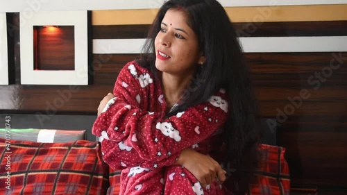 Young, Beautiful and Cute Indian woman in pink clothes smile memory in her bedroom
