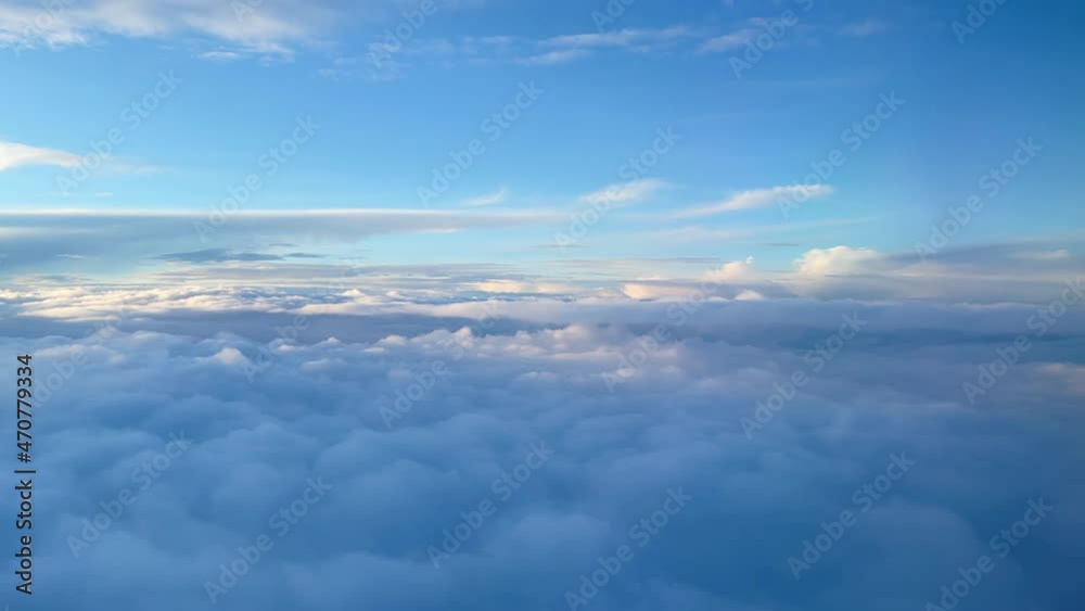 Aerial view of clouds from the airplane window at sunset. Travel and nature concept. High quality 4k footage Aerial view of clouds from the airplane window at sunset. Travel and nature concept. High quality 4k footage