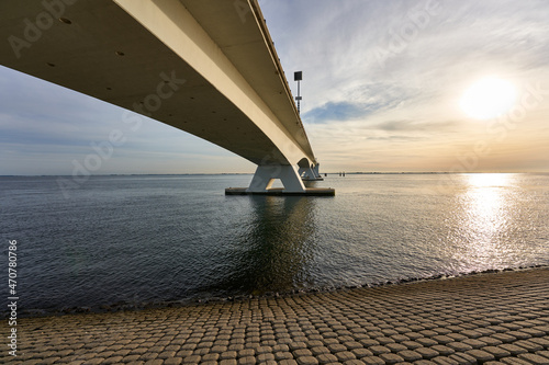 Longest Zeeland bridge in Holland. Construction of concrete and steel connects the municipalities of Schouwen-Duiveland and Noord-Beveland. Backlight shot in the evening. © Jan