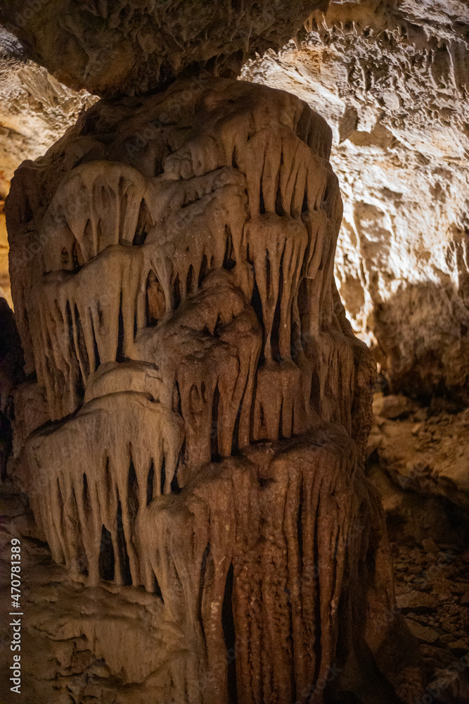 abstract background of stalactites, stalagmites and stalagnates in a cave, vertical