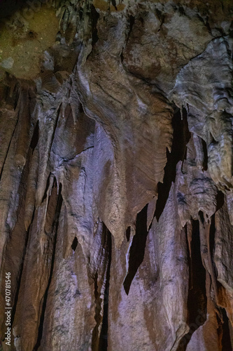 abstract background of stalactites, stalagmites and stalagnates in a cave, underground, vertical
