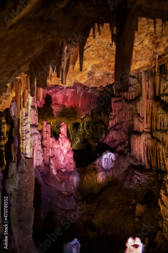 abstract background of stalactites, stalagmites and stalagnates in a cave, underground, vertical photo