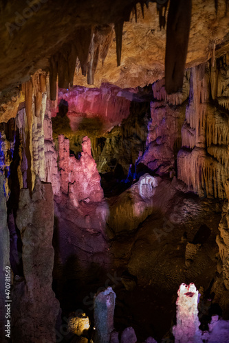 fabulous purple abstract background of stalactites  stalagmites and stalagnates in a cave underground  vertical