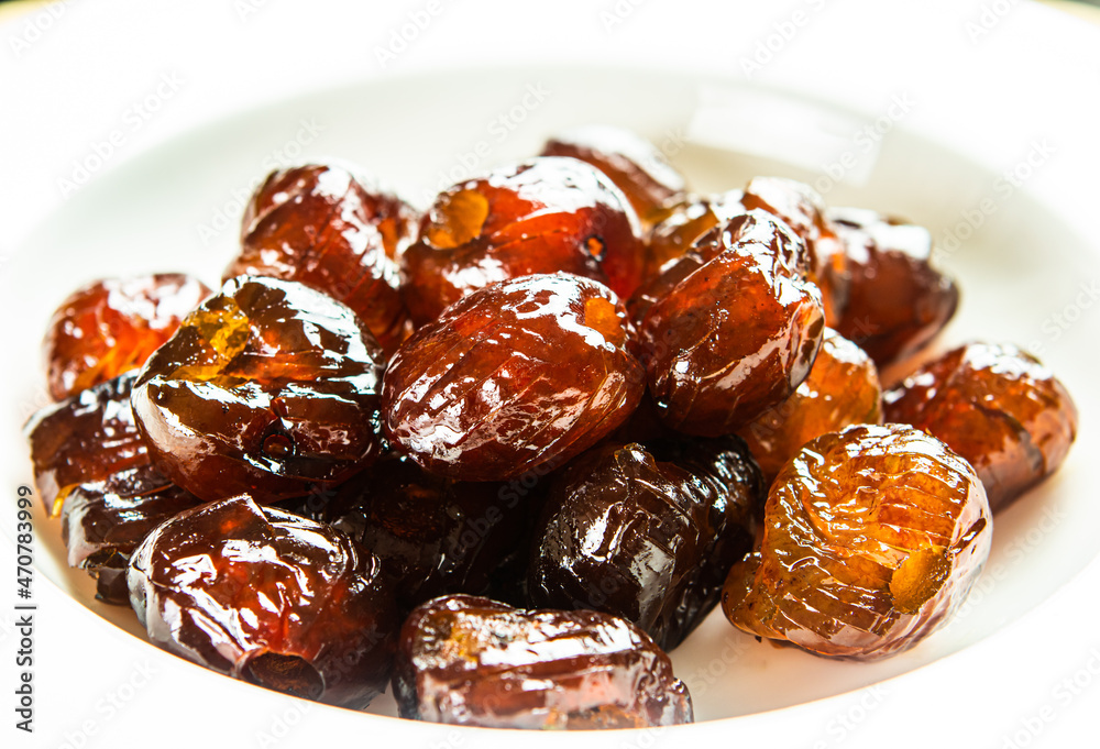Close up sweet dried jujubes in plate ,  in studio  Chiangmai  Thailand.