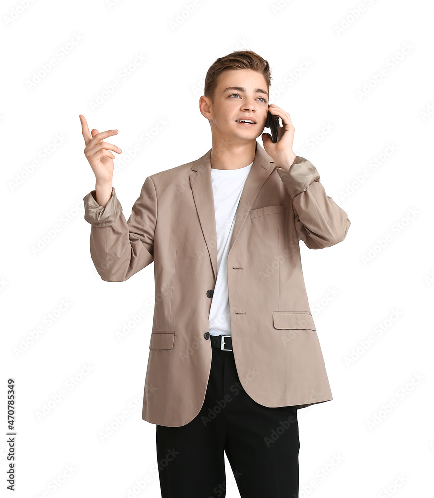 Teenage boy talking by mobile phone on white background Teenage boy talking by mobile phone on white background