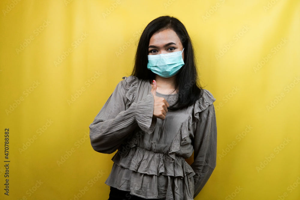 Beautiful young woman wearing a mask with thumbs up hands, okay hands, agreement, good work isolated Beautiful young woman wearing a mask with thumbs up hands, okay hands, agreement, good work isolated