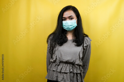 Beautiful young woman wearing mask isolated