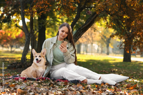 Young woman with cute Corgi...