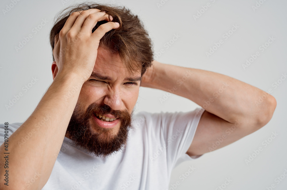 man holding his head pain stress emotions isolated background man holding his head pain stress emotions isolated background