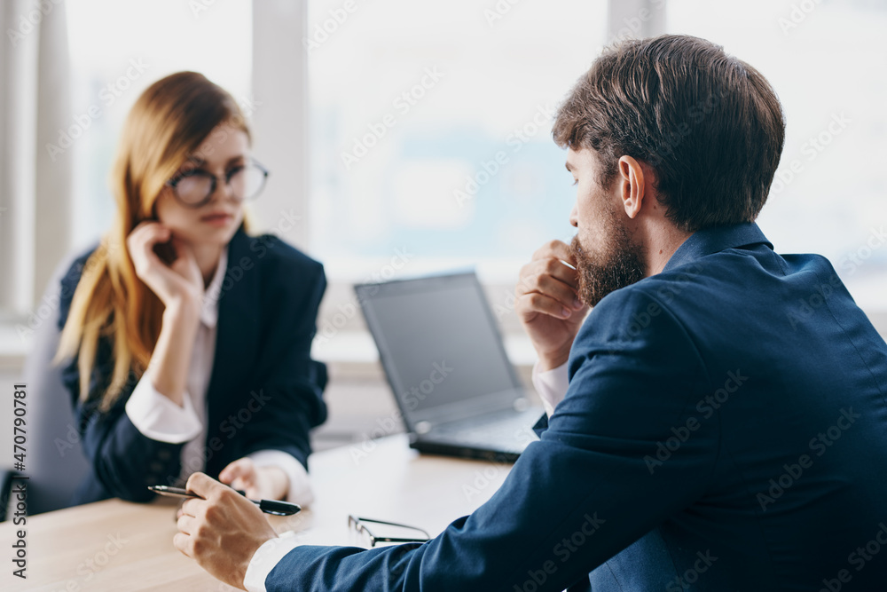 managers in the office in front of a laptop career network professionals managers in the office in front of a laptop career network professionals