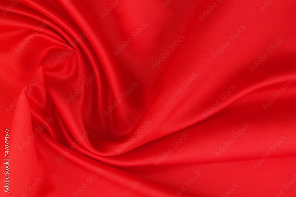 Obraz premium Red satin or silk fabric backdrop. Beautiful wallpaper, wedding background or design element. 