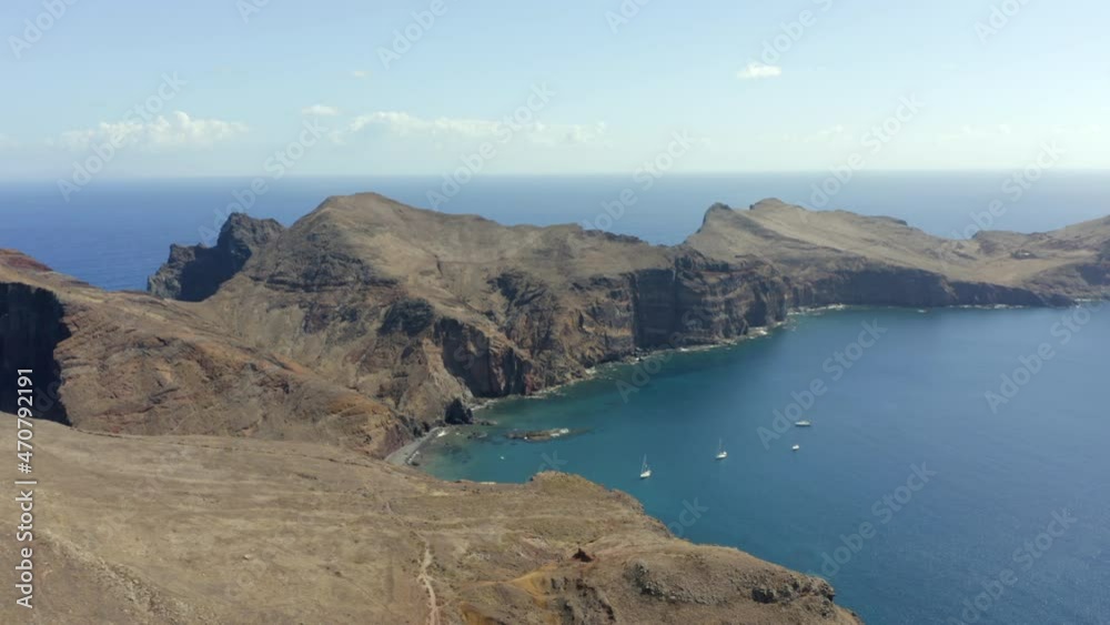 Boat Sailing In The Coast Of North Atlantic Ocean With Panorama Of Ilot de Cevada In Ponta de Sao Lourenco, Madeira, Portugal. - aerial Boat Sailing In The Coast Of North Atlantic Ocean With Panorama Of Ilot de Cevada In Ponta de Sao Lourenco, Madeira, Portugal. - aerial