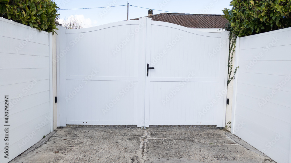 white double steel entry gate aluminum portal of home door of suburbs house in street view