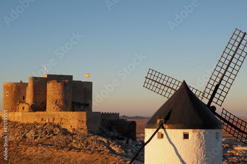 windmill and castle at sunset in consuegra  photo