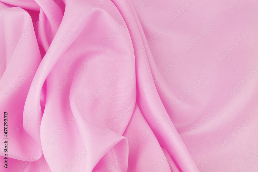 Obraz premium Pink satin or silk fabric background. 