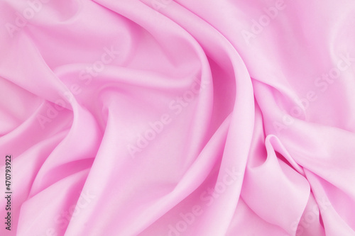 Pink satin or silk fabric background. 