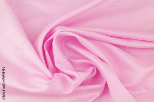 Pink satin fabric background. Wedding backdrop or holidays design element.