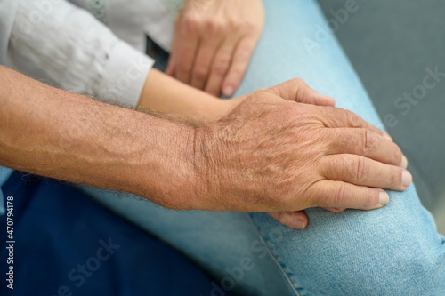 Close up of elderly hands holding each other , Grandfather hands is holding grandma hands , together , family concept.