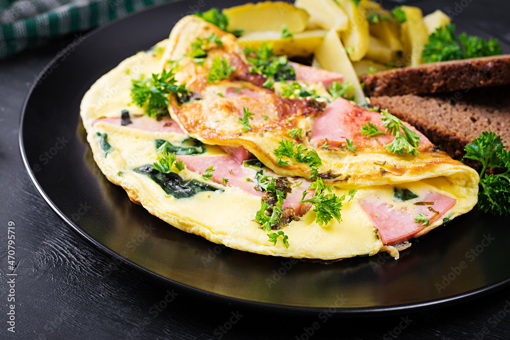 Omelet with boiled sausage and herbs, served with fermented cucumbers and bread. Rustic cuisine. Omelette. Omelet with boiled sausage and herbs, served with fermented cucumbers and bread. Rustic cuisine. Omelette.