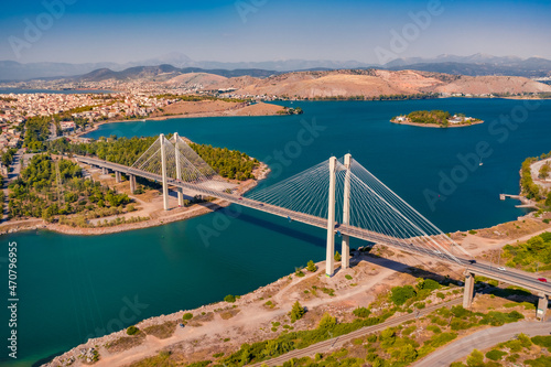 Splendid summer view of High Bridge Evripos. Amazing morning cityscape of Chalcis town, Greece. Bright seascape of Aegean sea, North Euboean Gulf. Traveling concept background..