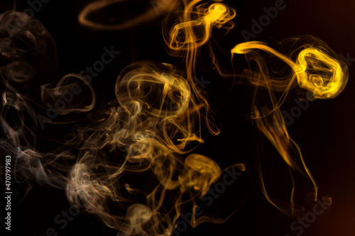 Abstract colorful smoke Weipa. Personal vaporizers fragrant steam. Concept of alternative non-nicotine smoking. Color smoke on dark background. E-cigarette. Evaporator. Blurry image, soft focus