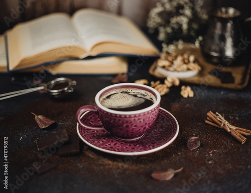 coffee in a purple mug and books 